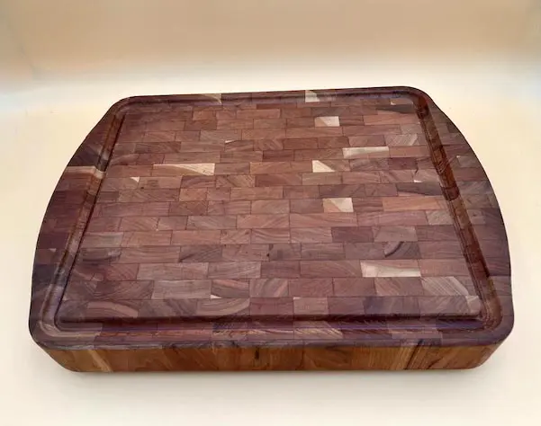 Round Cherry end grain butcher block board with a checkerboard pattern, displayed on a plain background.