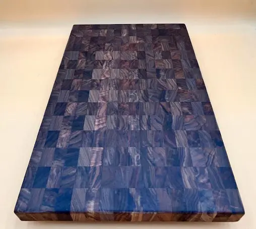 A hand crafted MAPLE BUTCHER BLOCK CUTTING BOARD MEDIUM with a blue pattern on it.