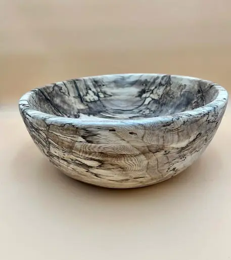 A HACKBERRY SALAD BOWL LARGE with a black and white pattern on it.