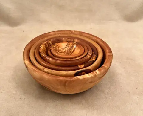 Olivewood nested set bowls on a cream surface