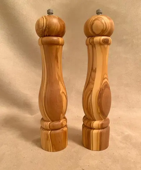 Set of two salt and pepper grinder on a cream background