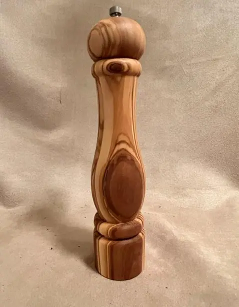 OLIVE WOOD SALT AND PEPPER MILLS on a table.