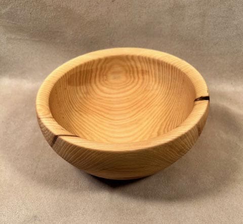 A wooden bowl made from a piece of Hackberry salad bowl wood.