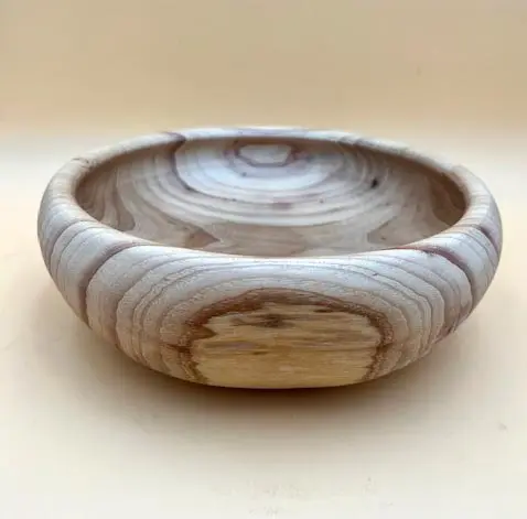 A round reclaimed wooden tray on a white background.