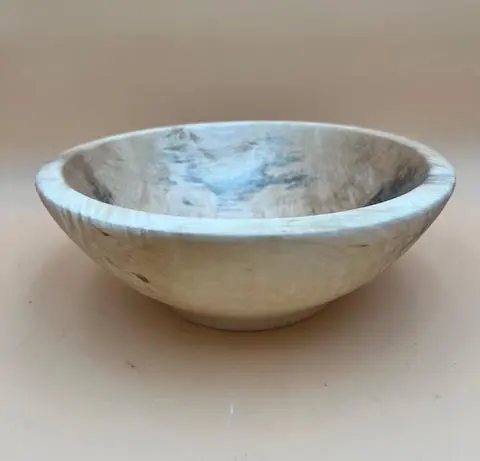 A small, round, CHESTNUT NEST SET BOWL with natural gray and white veining, displayed against a neutral beige background.