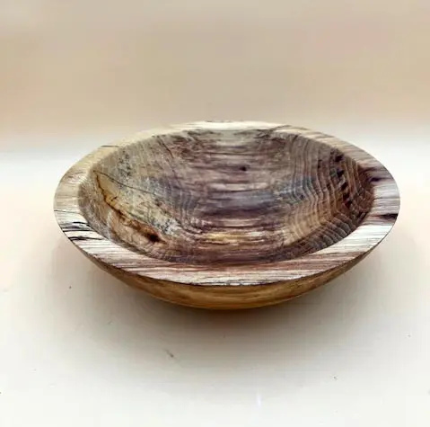 An all-natural hand-turned Ambrosia Maple Salad Bowl with natural grain patterns, placed on a white surface.
