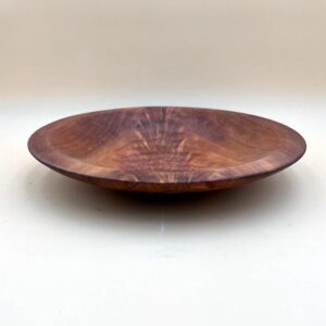 A Wild Cherry Artisan Bowl with a rich brown color and visible wood grain patterns, positioned on a light gray background.