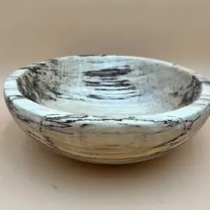 A GEORGIA HACKBERRY SALAD BOWL with a rustic white and black distressed finish, displayed against an all-natural background.