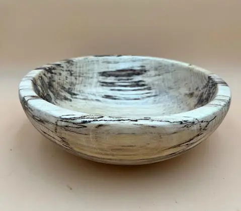 A GEORGIA HACKBERRY SALAD BOWL with a rustic white and black distressed finish, displayed against an all-natural background.