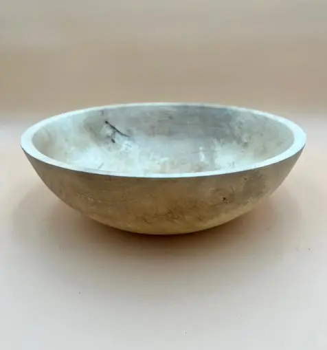 A simple, worn MAPLE SALAD BOWL with a slightly tarnished surface, placed against a plain, light-colored background.
