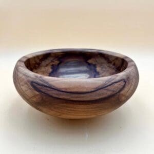 Wooden bowl with purple and brown grain.