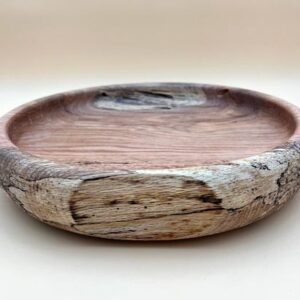 Handcrafted wooden bowl with grain patterns.