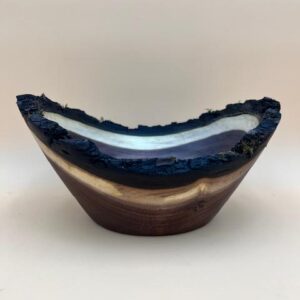 Wooden bowl with black and purple streaks.