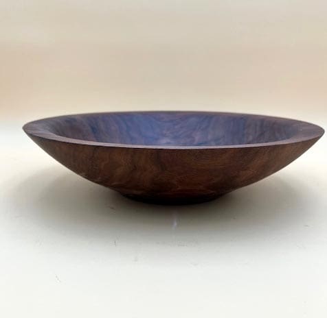 Wooden bowl with a dark finish.