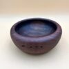 Hand-carved wooden bowl with dark grain.