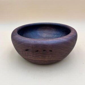 Hand-carved wooden bowl with grain detail.