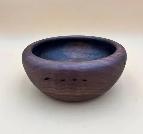 Hand-carved wooden bowl with grain detail.